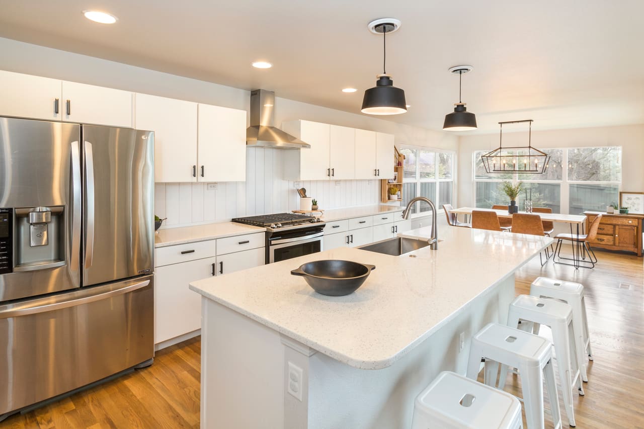 A bright kitchen with marble counters and brass fixtures — ready for listing photos.