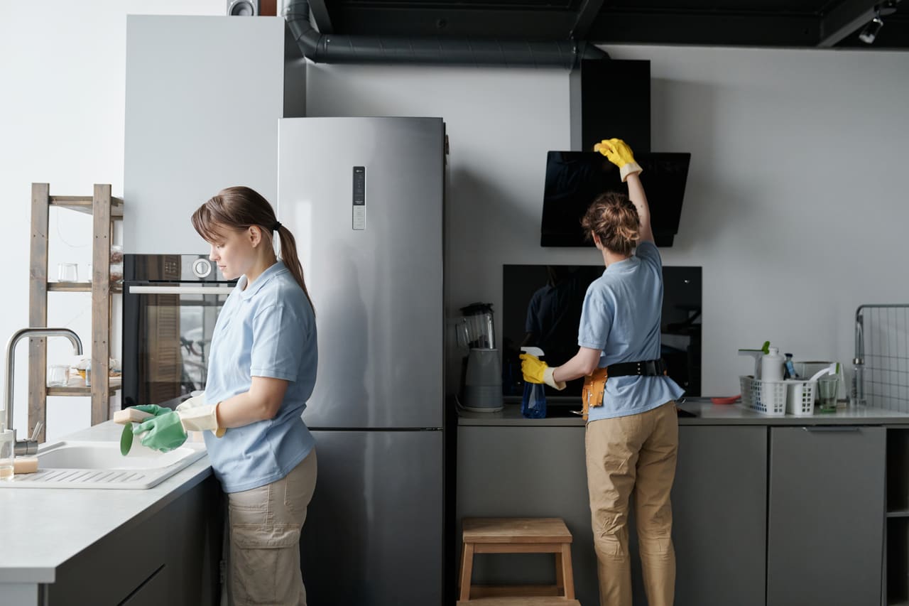 Two teammates working together in a modern kitchen.